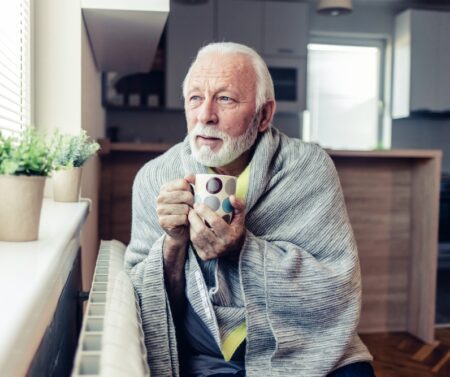 Senior,Man,Wearing,Warm,Clothes,Is,Freezing,At,Home,And